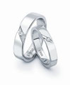 A remarkable pair of platinum love bands in satin finish and prong set solitaires.Code is PTK72-73